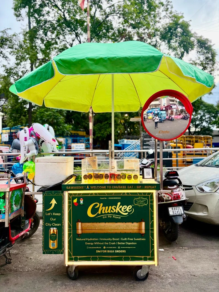 Chuskee stall under green umbrella